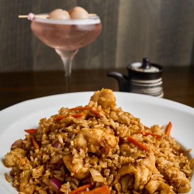 Chicken Fried Rice with a pink cocktail drink in the background.