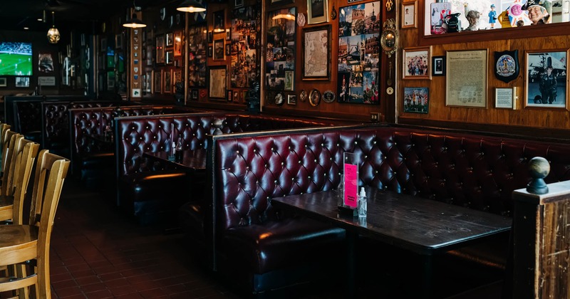 Interior, booth seating area, wall decorated with lots of pictures