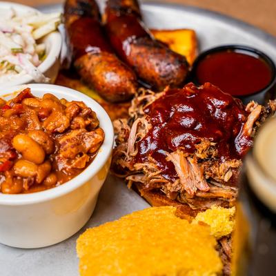 Sausage and Pork with Baked Beans & Apple Slaw, Close up.