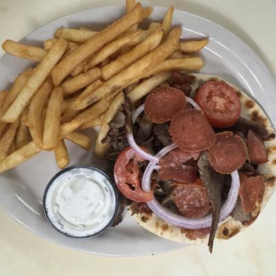Flatbread sandwich served with fries and dipping sauce.