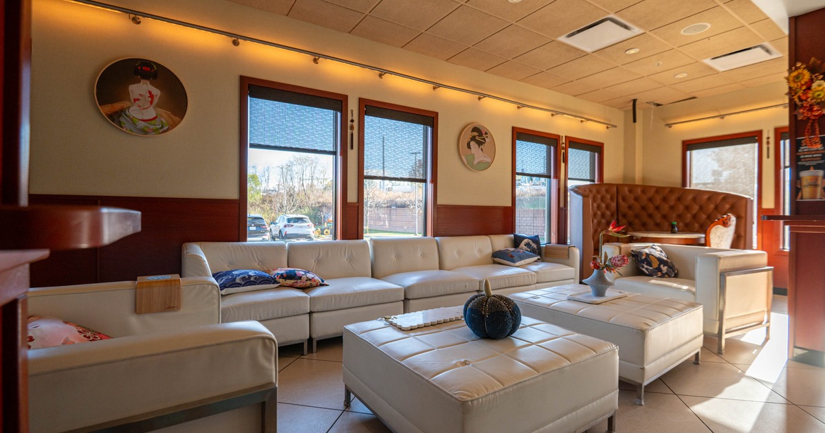 Interior, lounge with white seating, colorful pillows, and decorative objects