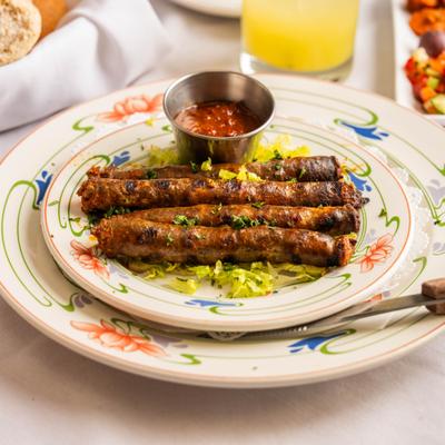 Grilled lamb and beef sausages with dipping sauce.