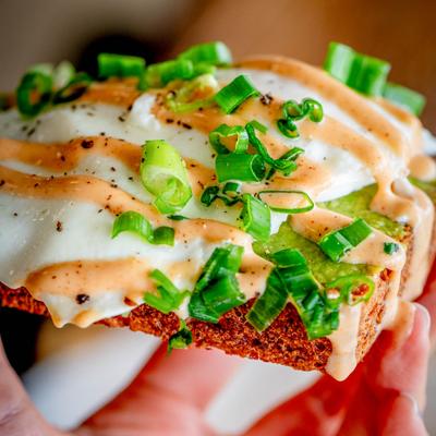 Avocado Toast with egg whites, chipotle aioli, and scallions.