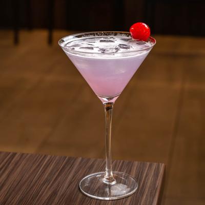 Lavander martini with cherry garnish.