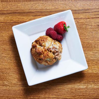 Scone, with strawberries and raspberries on the side.