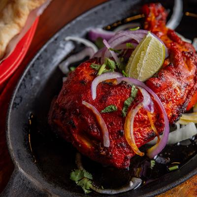 Marinated chicken leg, closeup.