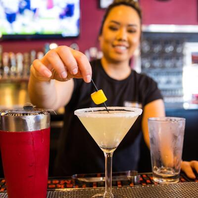 Employee making yellow martini