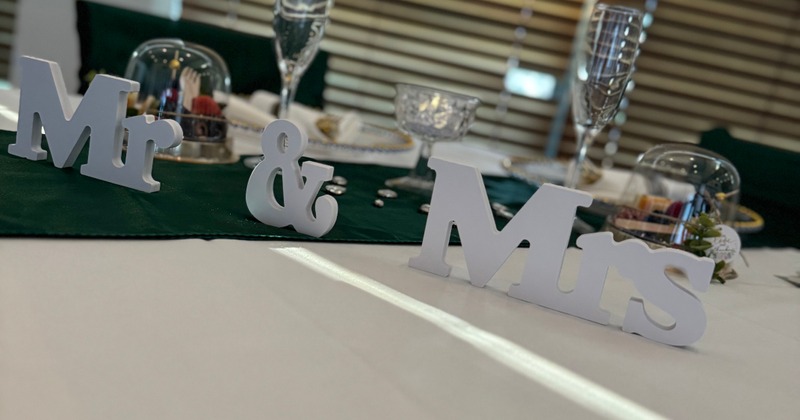 Mr. and Mrs. signs on a wedding head table