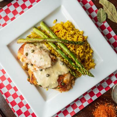 Crab stuffed flounder, with yellow rice, asparagus, and creamy sauce.