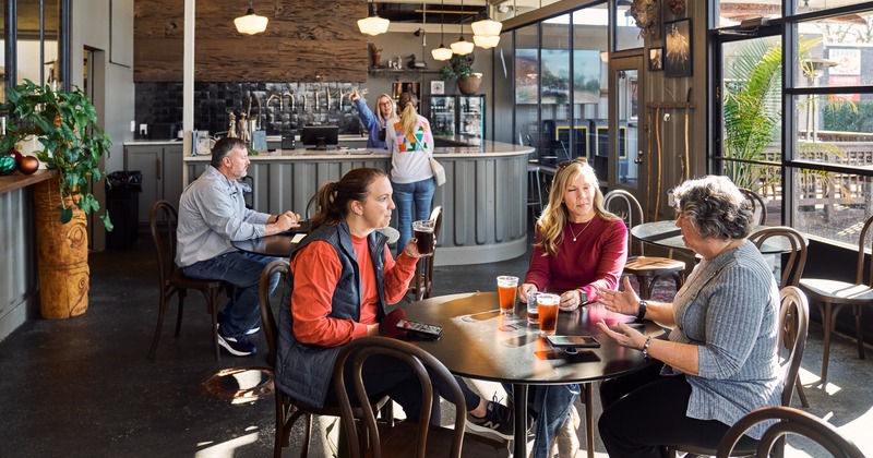 Interior, diner area, tables, chairs, bar behind, guests