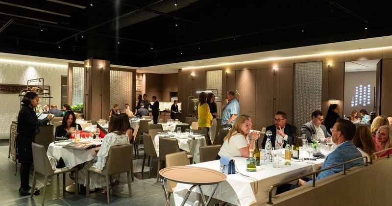 Interior, dining area, guests chatting and enjoying their food and drinks
