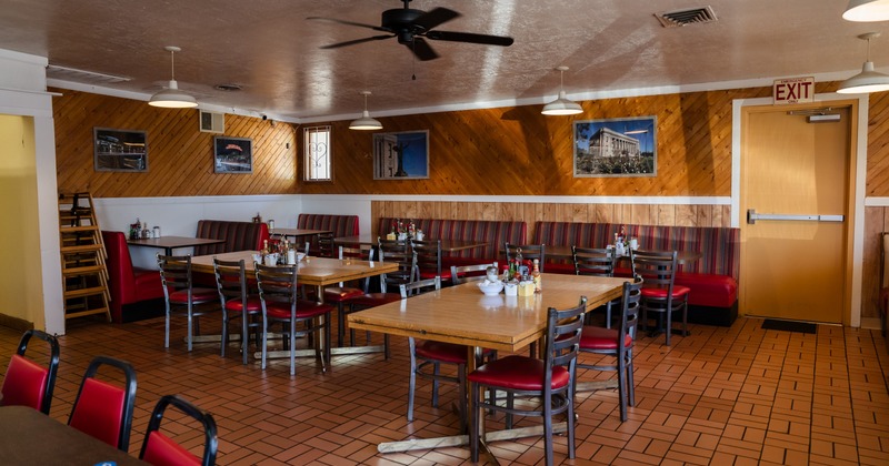 Interior, dining space with tables and chairs, fans on the ceiling