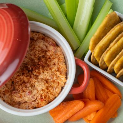 Charleston Pimento Cheese with crackers, celery, and carrots, top view.