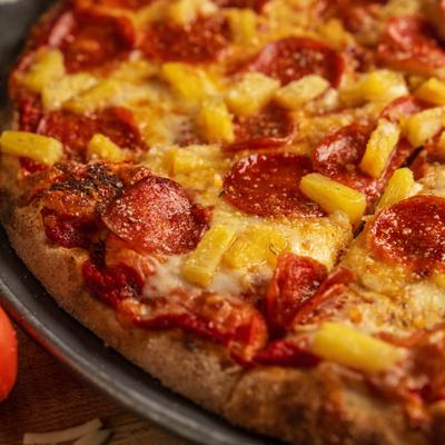 Pepperoni and pineapple pizza, close up.