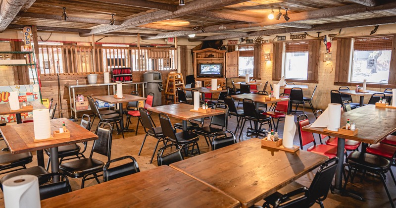 Interior, seating area, wooden walls, ceiling and floor, windows on the right