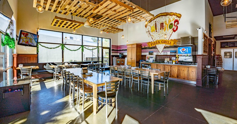 Interior, dining area, guest tables, TVs and decor on walls