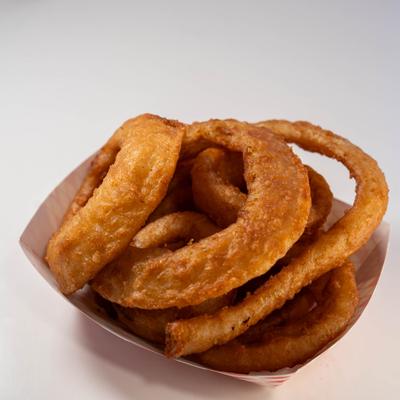 Onion rings served in a paper tray.