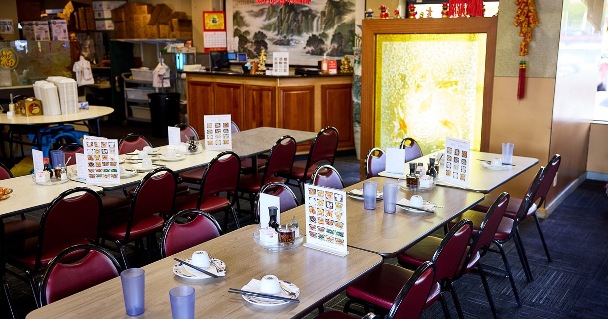 Cozy Chinese restaurant interior dining area with set dining tables