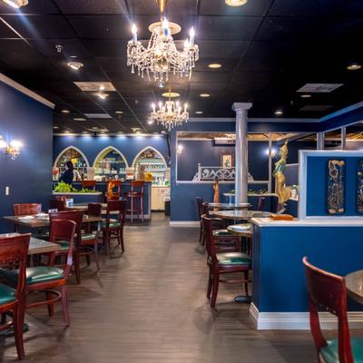 Interior featuring blue walls, decorative arch accents, and crystal chandeliers.