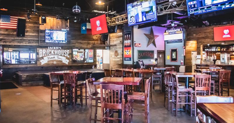 Interior, tables and seating, TVs, lots of decorations on wooden walls