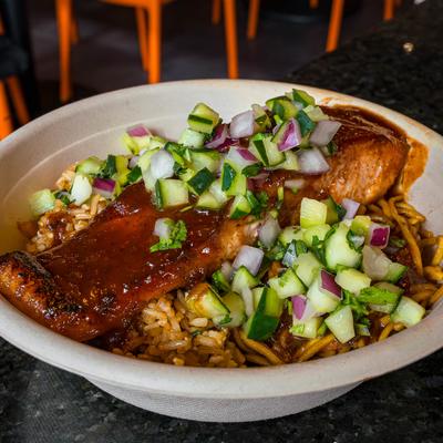 Grilled salmon on rice topped with rich sauce and cucumber-onion salsa.