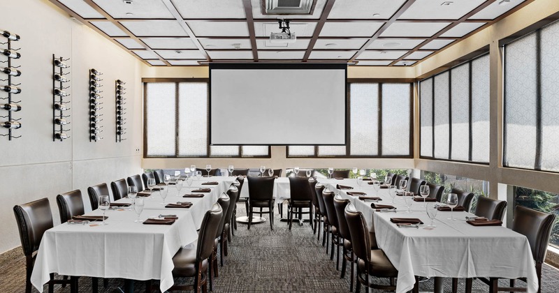 Private banquet room for corporate events, tables set for dining