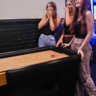 Customers playing Shuffleboard.