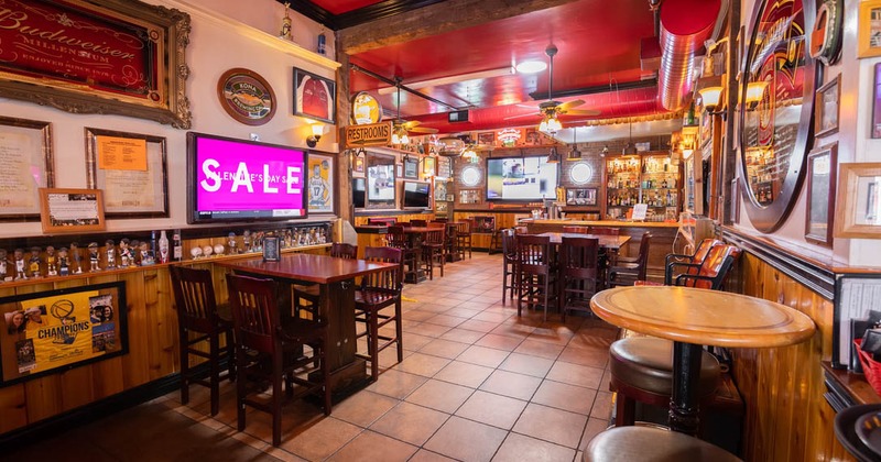 Interior of a pub-style bar with wooden tables and chairs