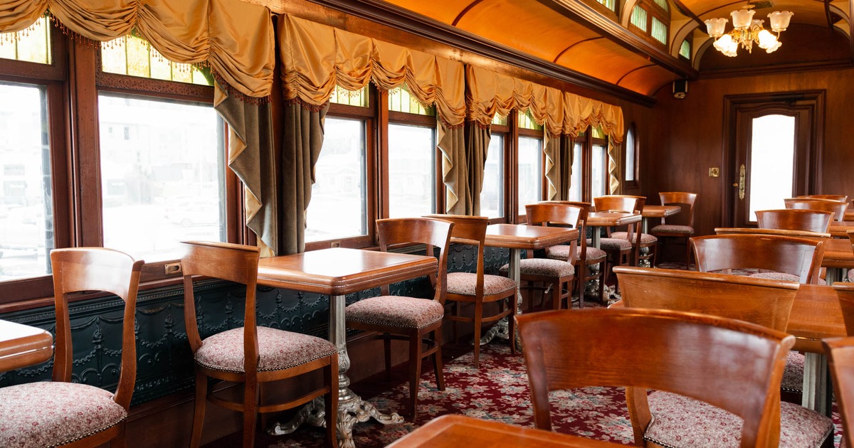 Train interior seating area, tables and chairs