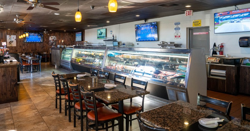 Interior, tables, chairs, refrigerated display cases, wall TVs, lights