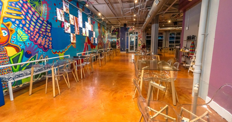 Interior, seating area, tables and chairs, mural on the wall