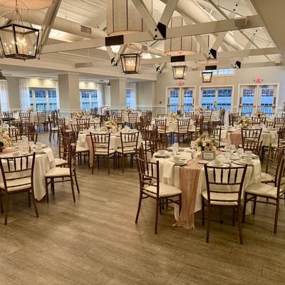 Bright reception room with neatly arranged tables.