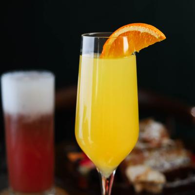 Mimosa garnished with an orange slice.