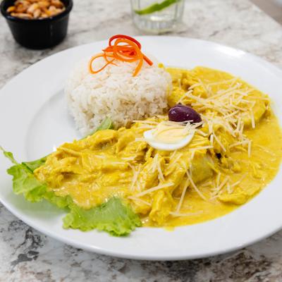 Shredded chicken in creamy yellow sauce, served with rice.
