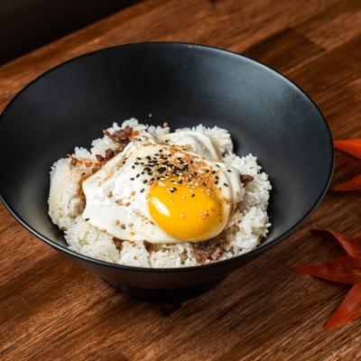 Bulgogi Rice Bowl topped with fried egg and sesame seeds.