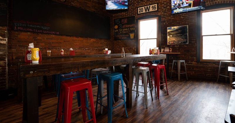 Inside, chairs and a long table near the windows