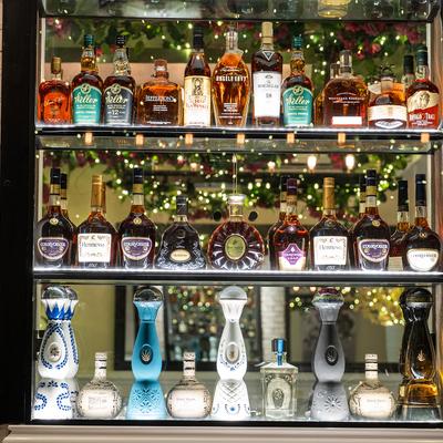Various liquor bottles on the shelf.