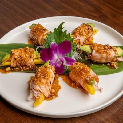 Sunflower roll featuring salmon wrapped around crab and avocado.