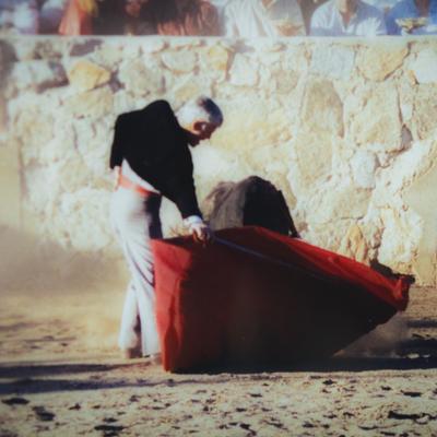 A bullfighter with a muleta and a sword during a corrida