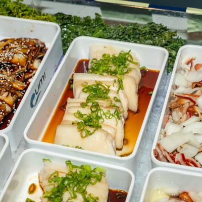 Sliced Pork Belly with Garlic Sauce topped with chopped green onions.