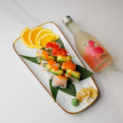 Sushi rolls topped with yellowtail, cucumber, and roe.