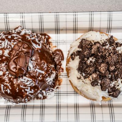 Chocolate Coconut donut alongside a Cookies and Cream donut.