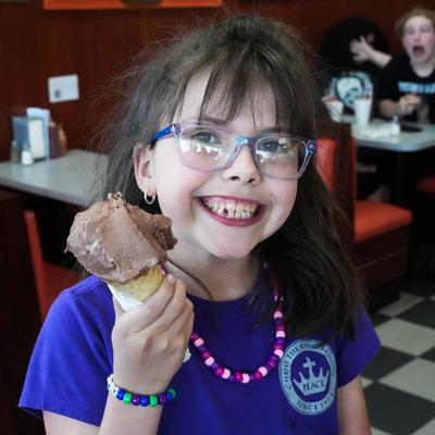 young girl eating ice cream cones.