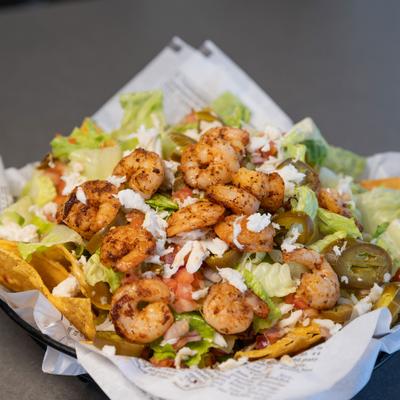 Nachos topped with shrimp, crab meat, pico de gallo, corn, jalapenos and cheese.