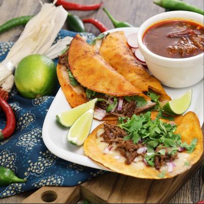 Plate of tacos with a dip.