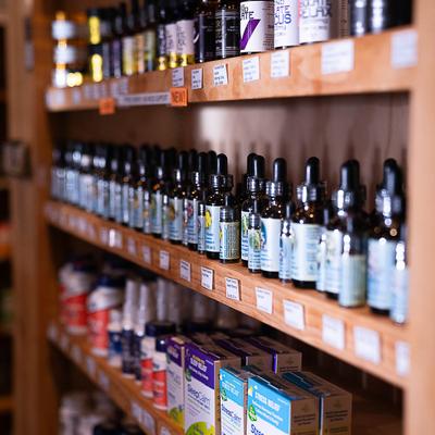 Herb shop shelves with various products.