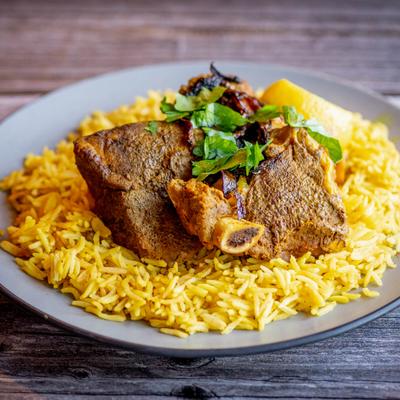 Slow-roasted lamb served over turmeric basmati smoked rice.