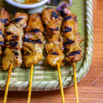 Grilled marinated pork satay.