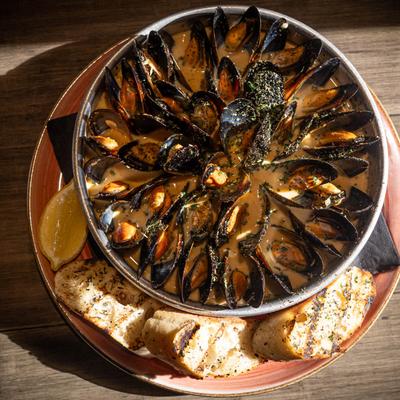 Pan sauteed mussels served with toasted baguettes.