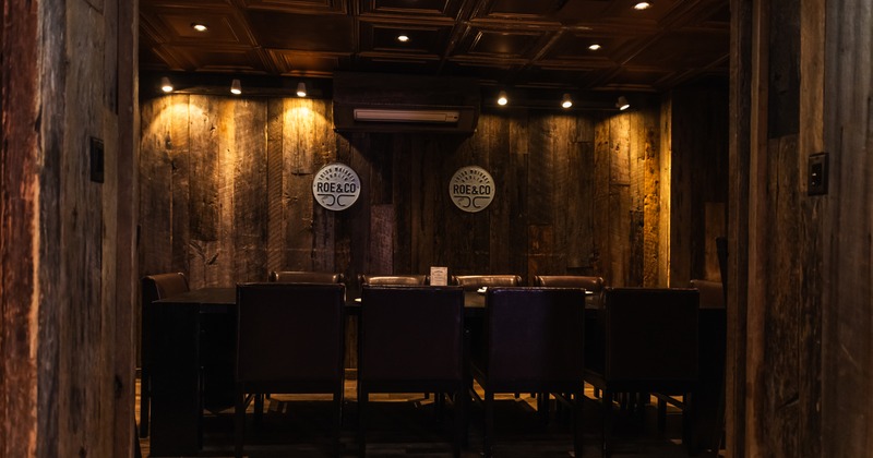 Diner room, table for 10, chairs, 2 logos on the wall behind
